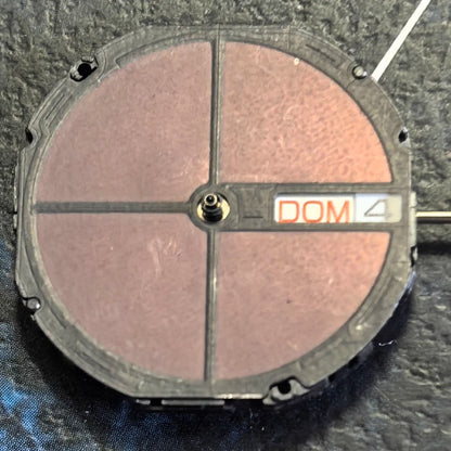 Citizen Eco-Drive E100 quartz watch movement showing day and date at 3 o'clock position.