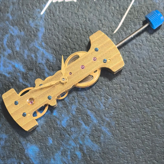 Golden long hand winding mechanical watch part by China Made, precision movement component for watch repair.