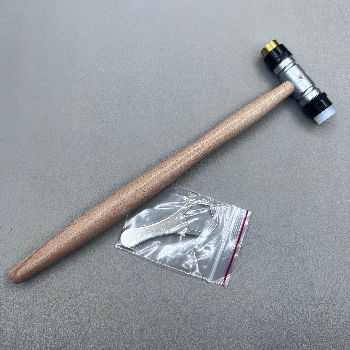 Swiss Tool Bergeon 30417 hammer with replaceable brass and synthetic ends for delicate watch repair tasks.