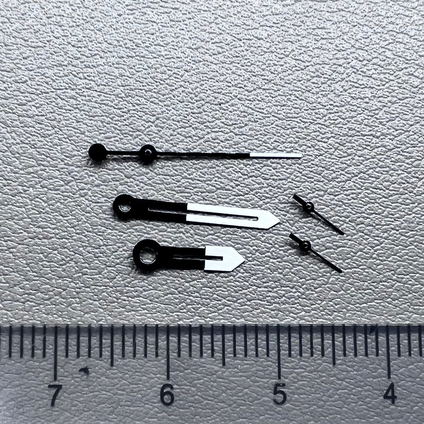 White and black watch hands designed for Ronda 5021D quartz movement.