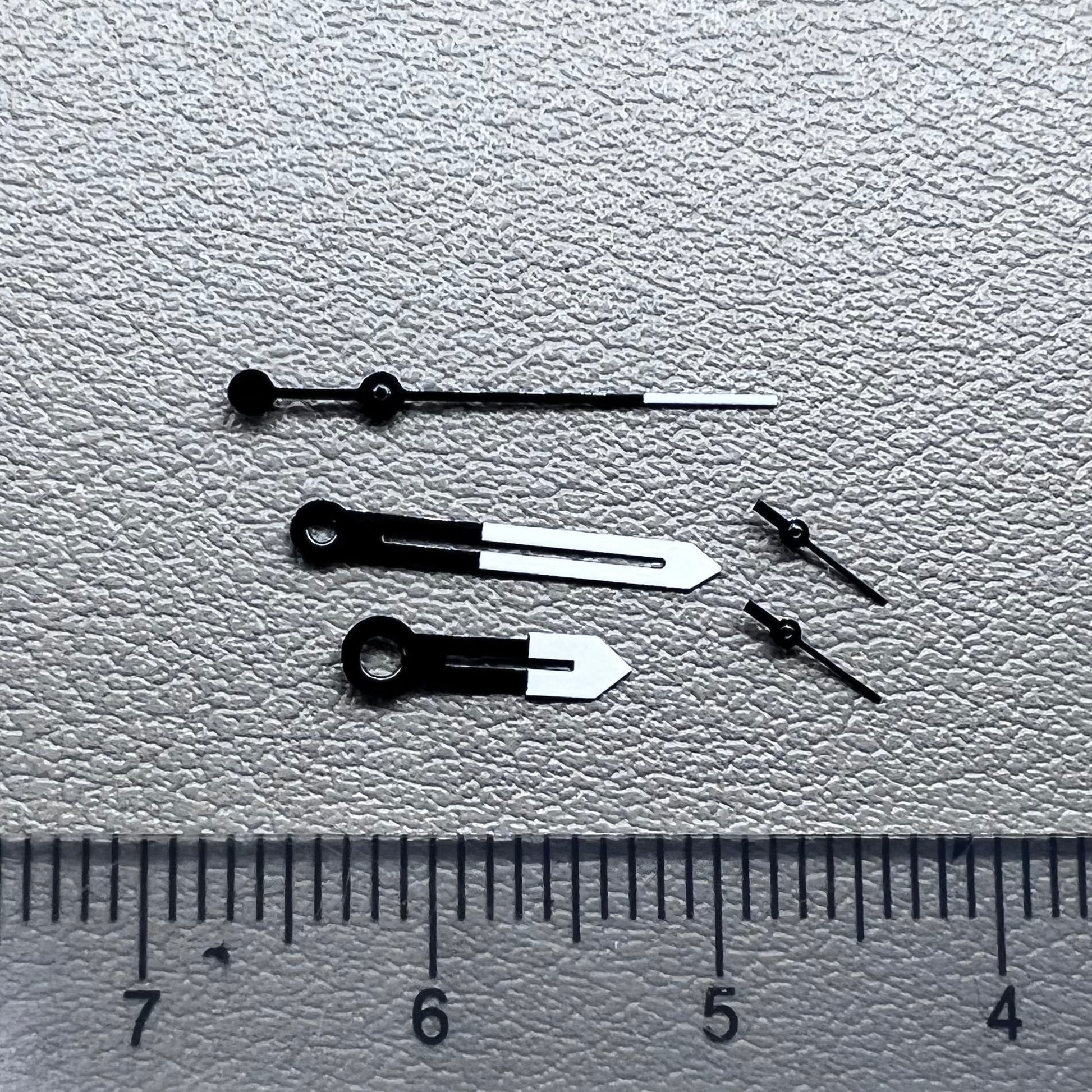 White and black watch hands designed for Ronda 5021D quartz movement.