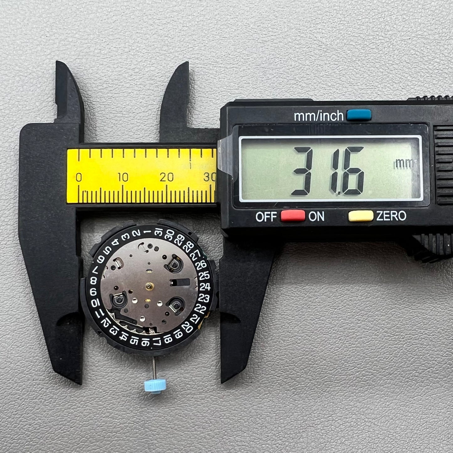 Swiss ETA G10.212 quartz watch movement with date at 4, large hands, small seconds, and black disk by ETA.
