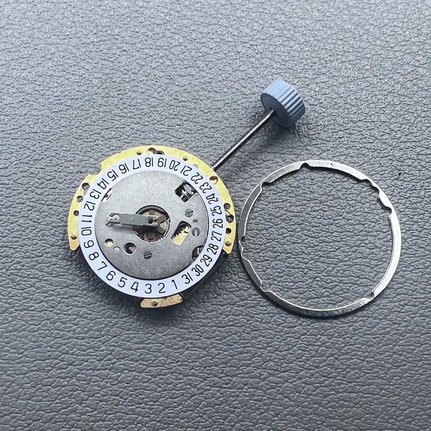 Swiss Ronda 775 quartz watch part with white date disk at 6 o'clock, ideal for precise repairs.