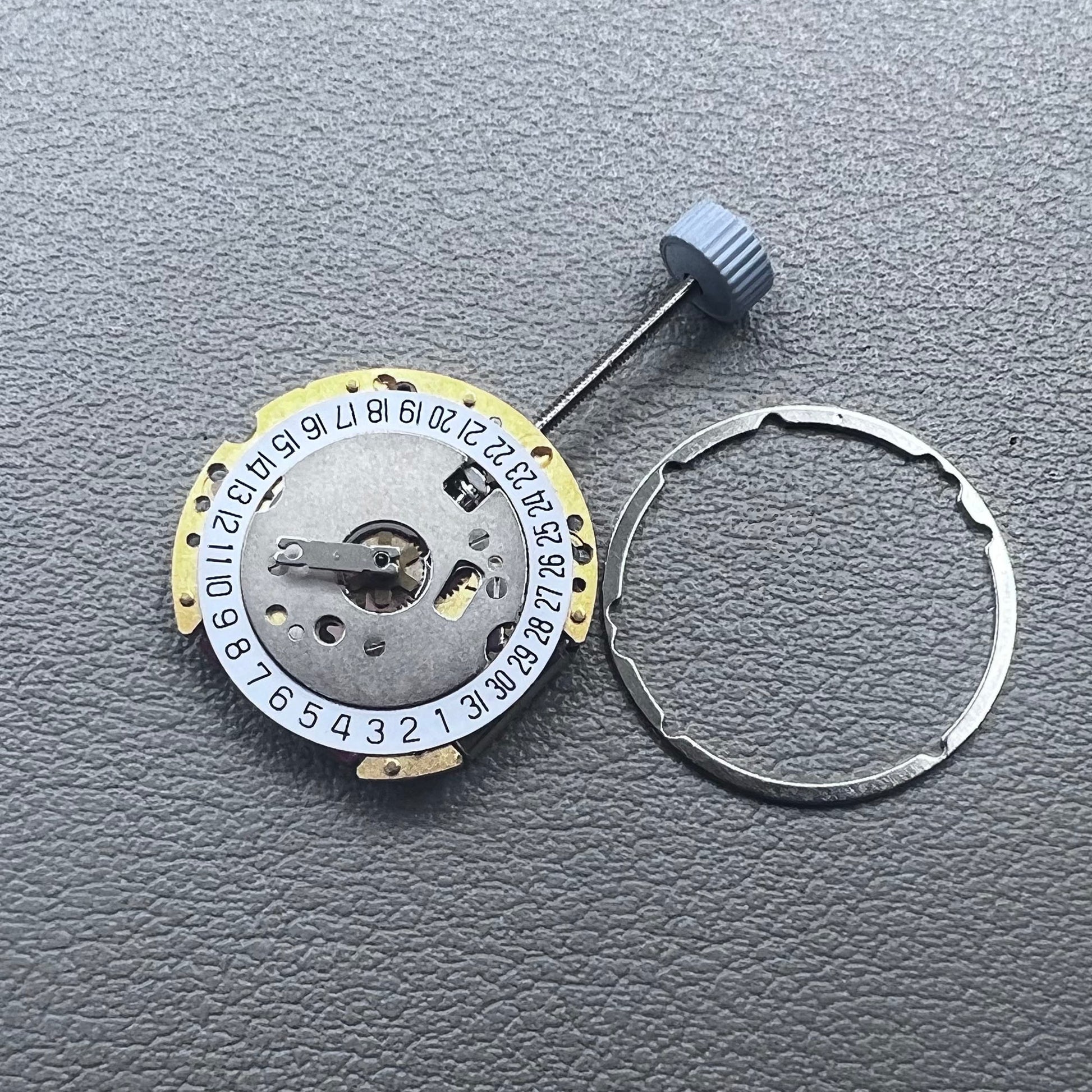 Swiss Ronda 775 quartz watch part with white date disk at 6 o'clock, ideal for precise repairs.