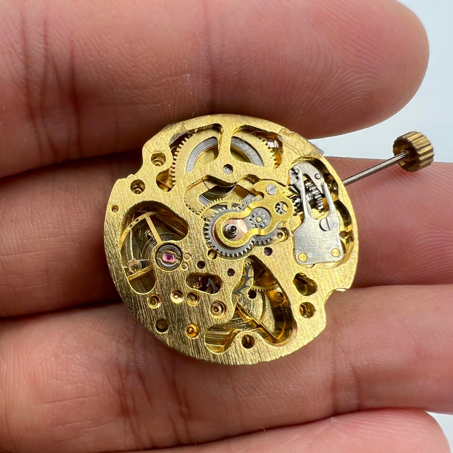 Golden 26.5mm 7120 automatic watch movement with detailed hollow mechanical design.