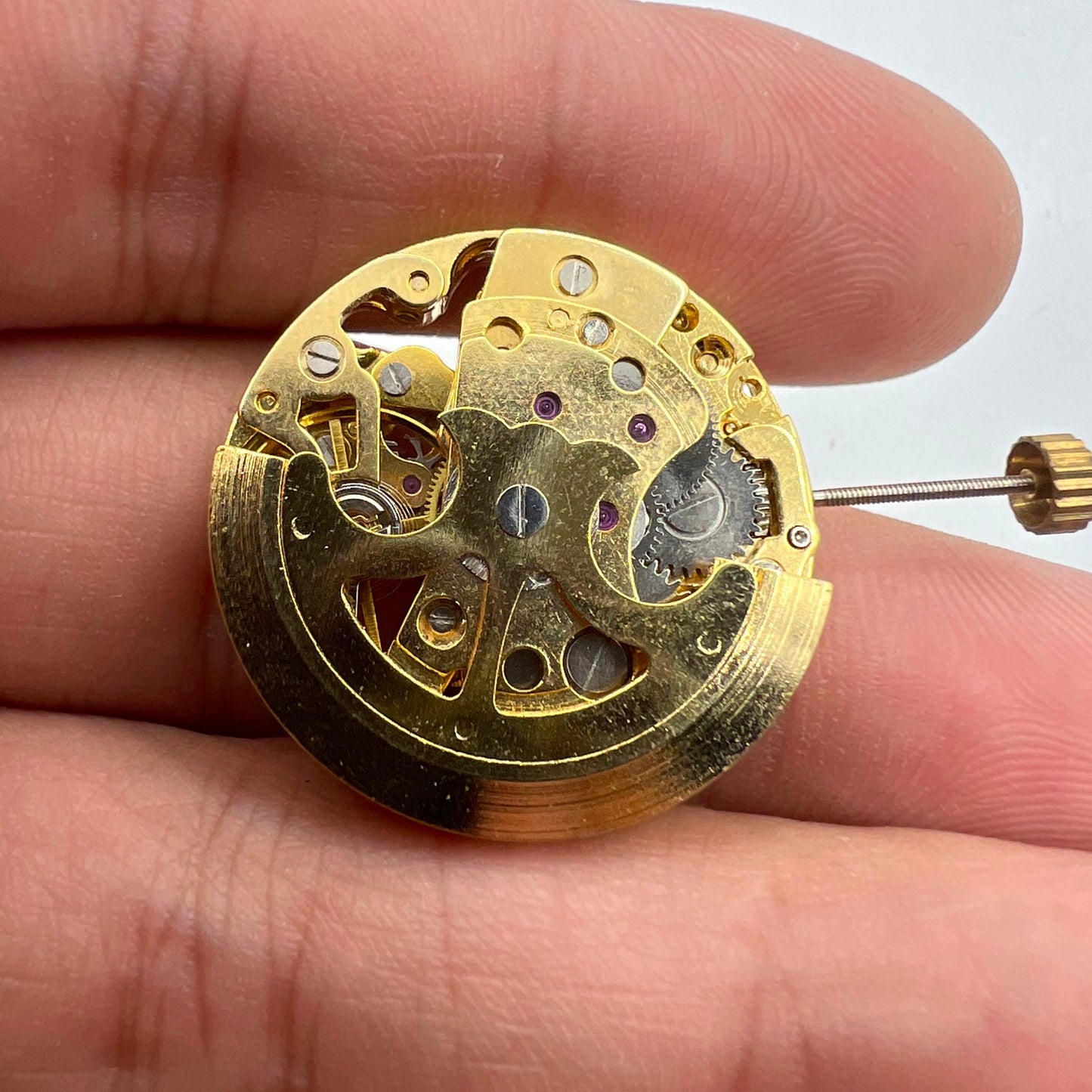 Golden 26.5mm 7120 automatic watch movement with detailed hollow design for watch accessories.