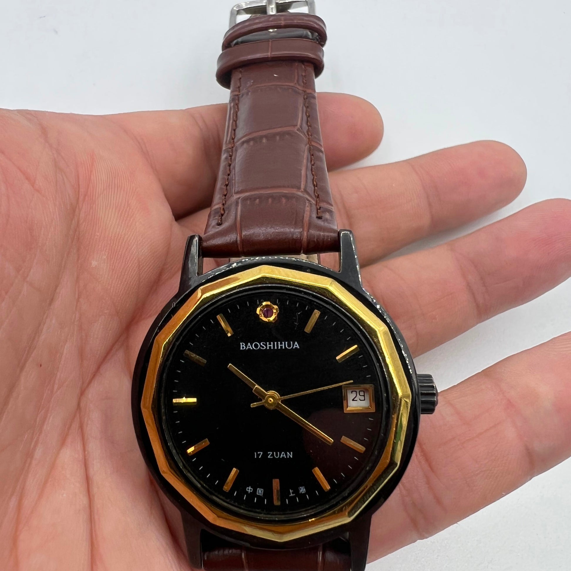 Classic 37mm Shanghai manual mechanical watch with black case and single calendar, showcasing timeless elegance.