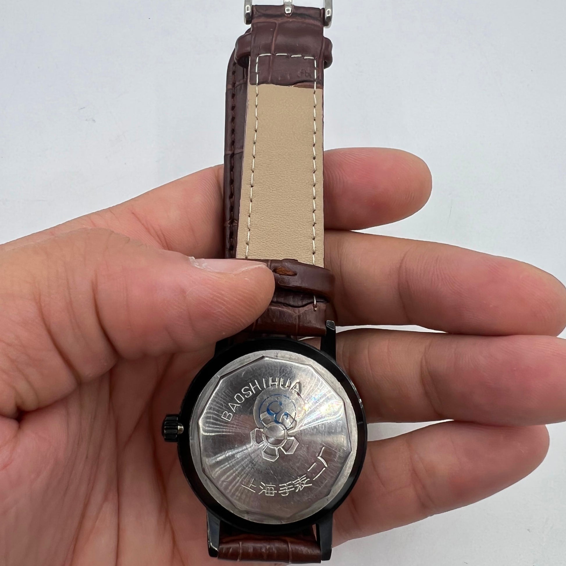 Classic 37mm Shanghai manual mechanical watch with single calendar, black case, and sleek dial design by Shanghai.