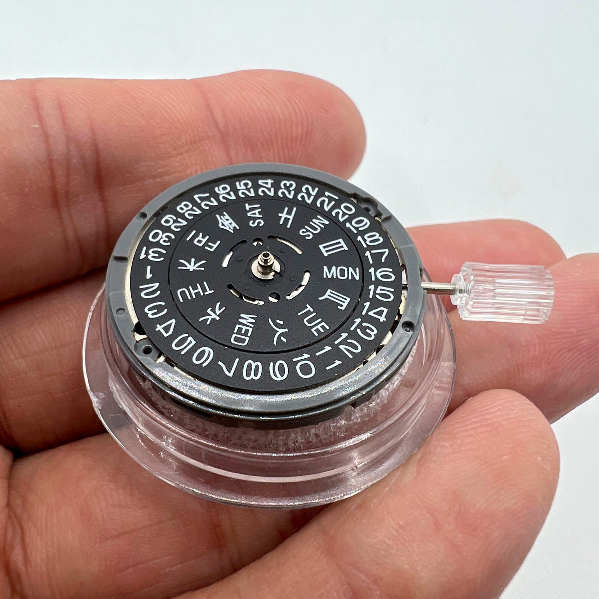 Miyota NH36A watch movement with black finish and green lume, highlighting 3 crown positions for accuracy by Miyota.