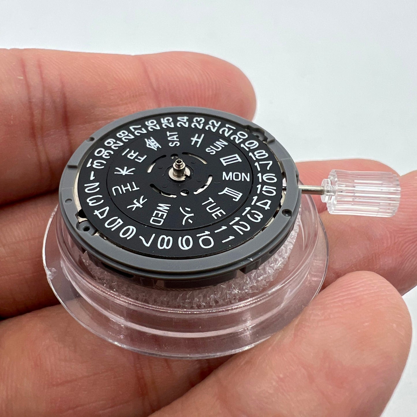 Miyota NH36A black-finish watch movement dial with green lume, featuring 3 crown positions for accurate time adjustment.