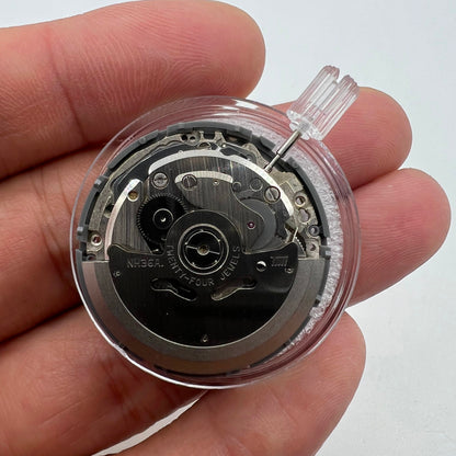 Miyota NH36A automatic watch movement with black finish, green lume, and triple crown positions for precise timekeeping.