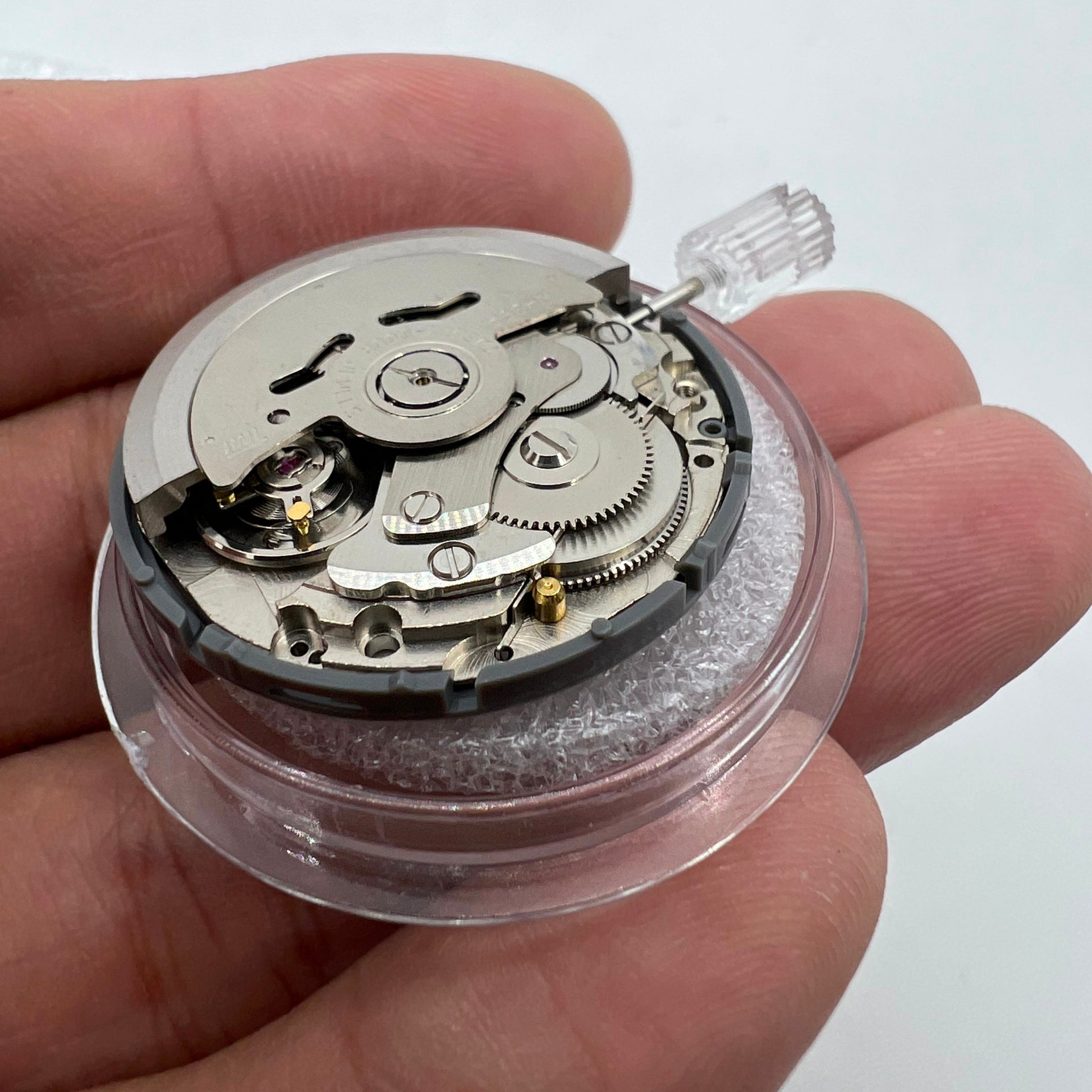 Miyota NH36A automatic watch movement with black finish, green lume, and tri-crown precision timing features.