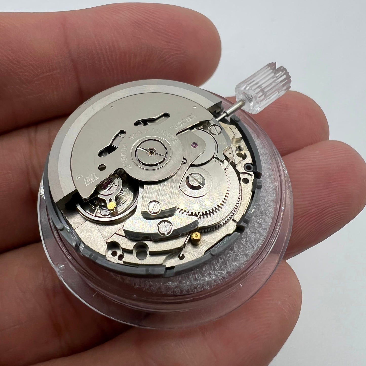 Miyota NH36A automatic watch movement with black finish, green lume, and triple crown for precision timing features.