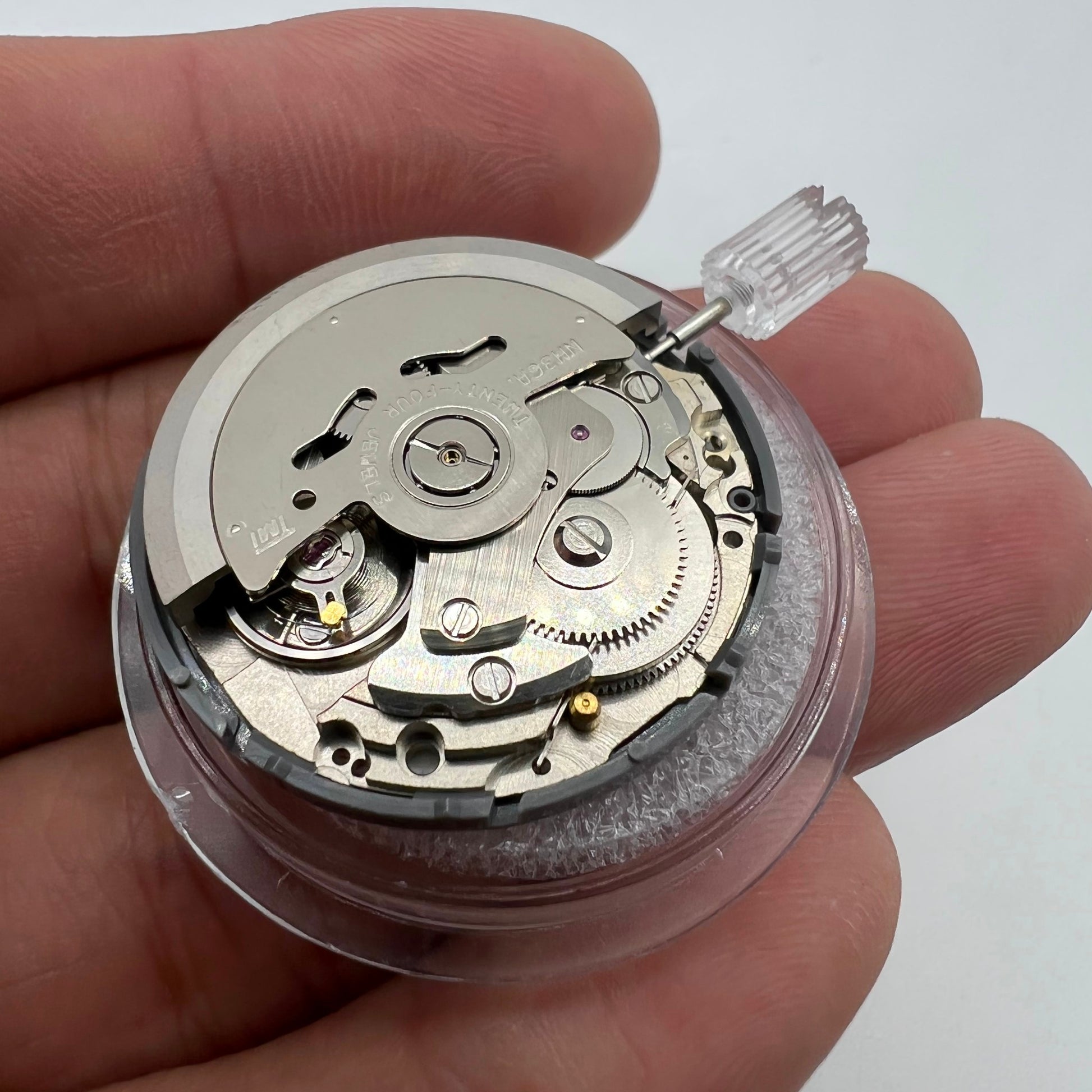 Miyota NH36A automatic watch movement with black finish, green lume, and triple crown for precision timing features.