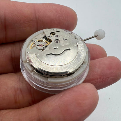 MINGZHU 2813 silver automatic watch showcasing mechanical movement with date and day display on dial.