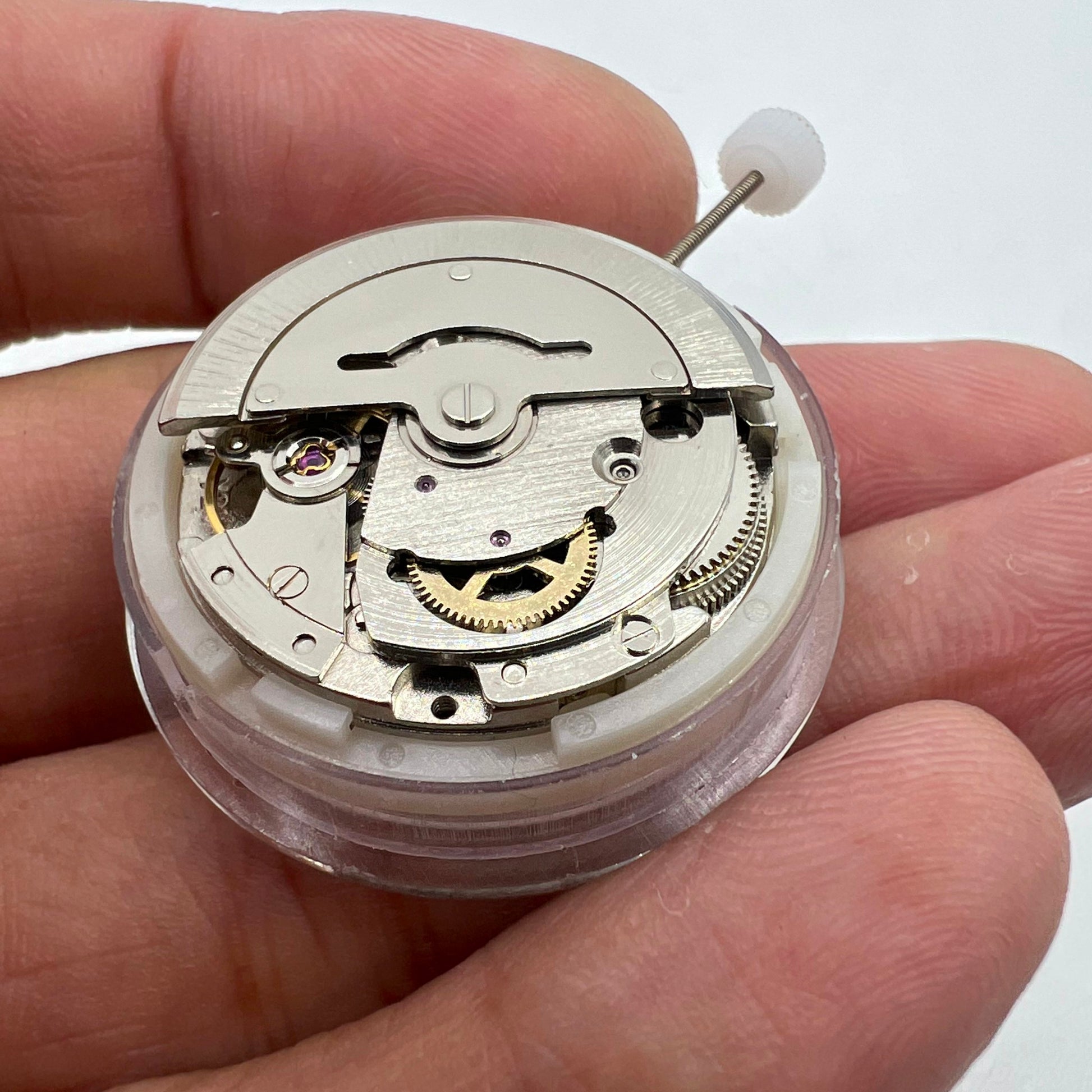 Silver automatic watch featuring MINGZHU 2813 movement, day-date display, and sleek stainless steel design.