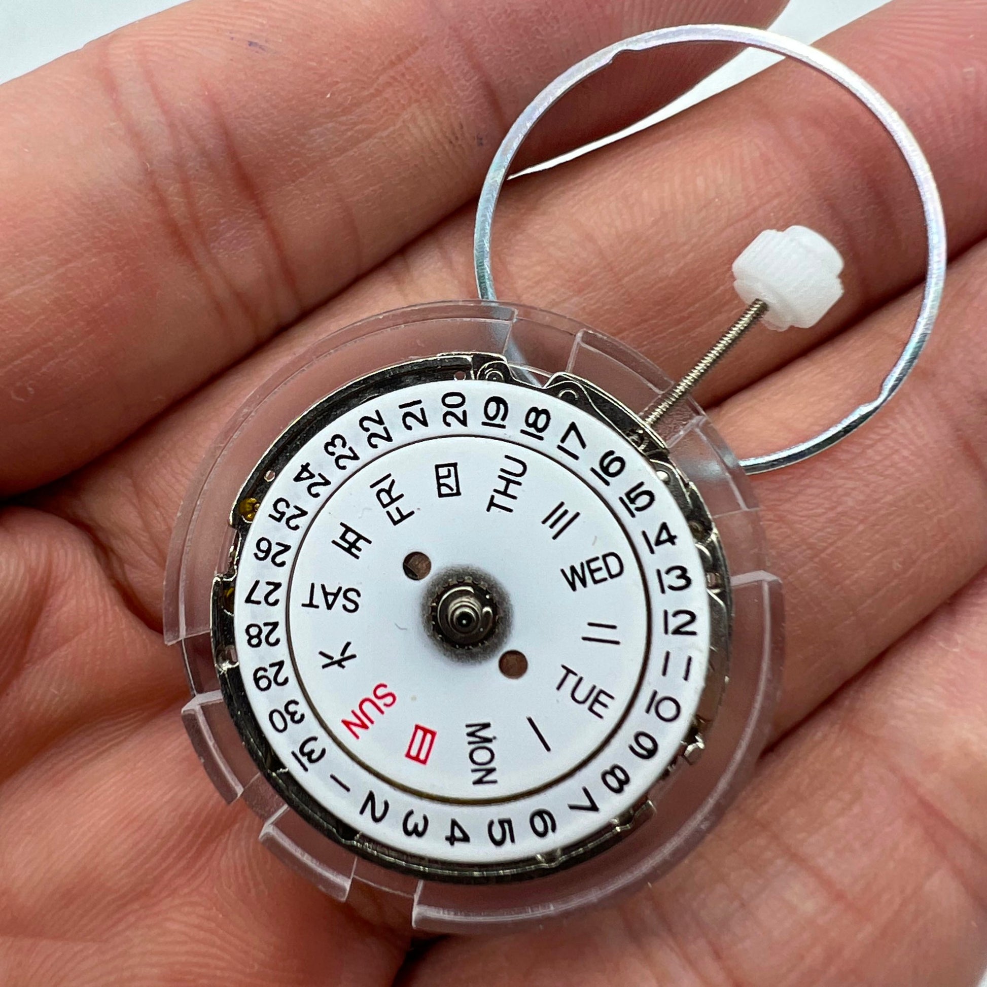 DG2813 automatic watch movement showing mechanical gears and day-date display for replacement parts.
