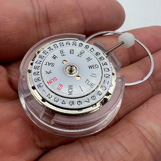 DG2813 automatic watch movement showing mechanical gears and day-date display for replacement parts.