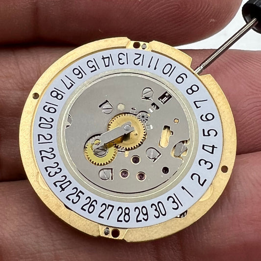 Swiss Made Ronda 1006 Slimtech golden quartz watch movement with date at 6 for repair.