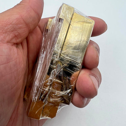 Brass and stainless steel pegwood tool by Woodcutter for precise watch cleaning and repair tasks.