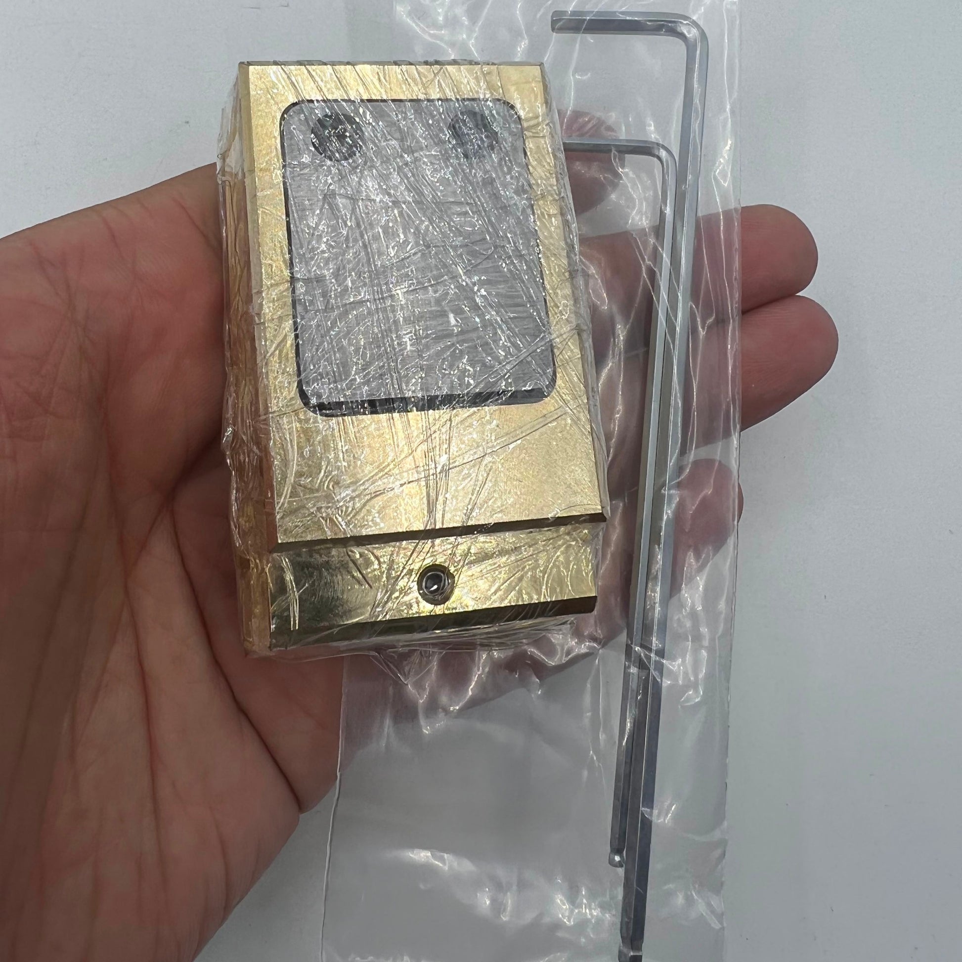 Woodcutter brass and stainless steel pegwood tool for precise watch repair and cleaning tasks.