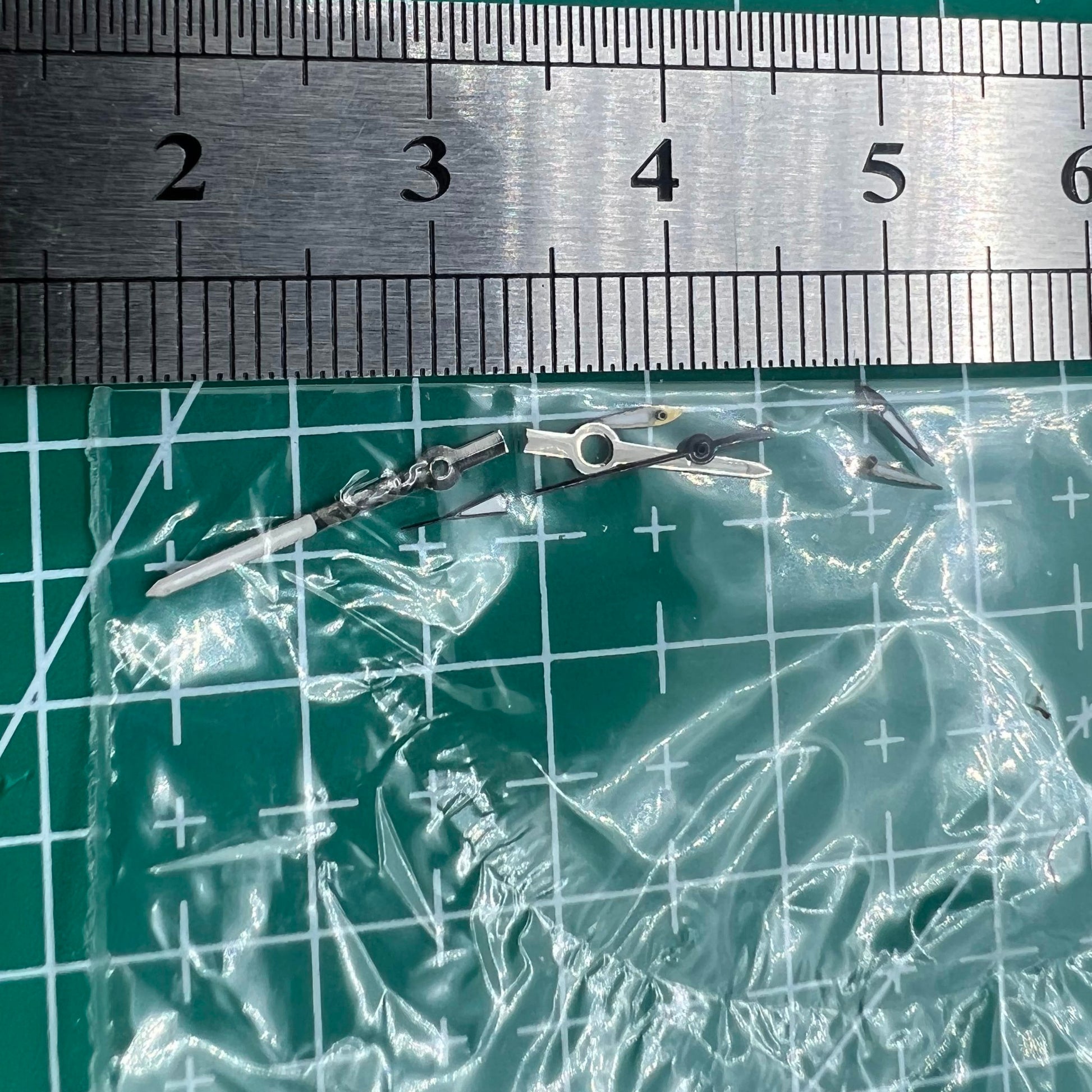 Silver and black 13mm luminous watch hands for Miyota OS series, enhancing visibility and style.