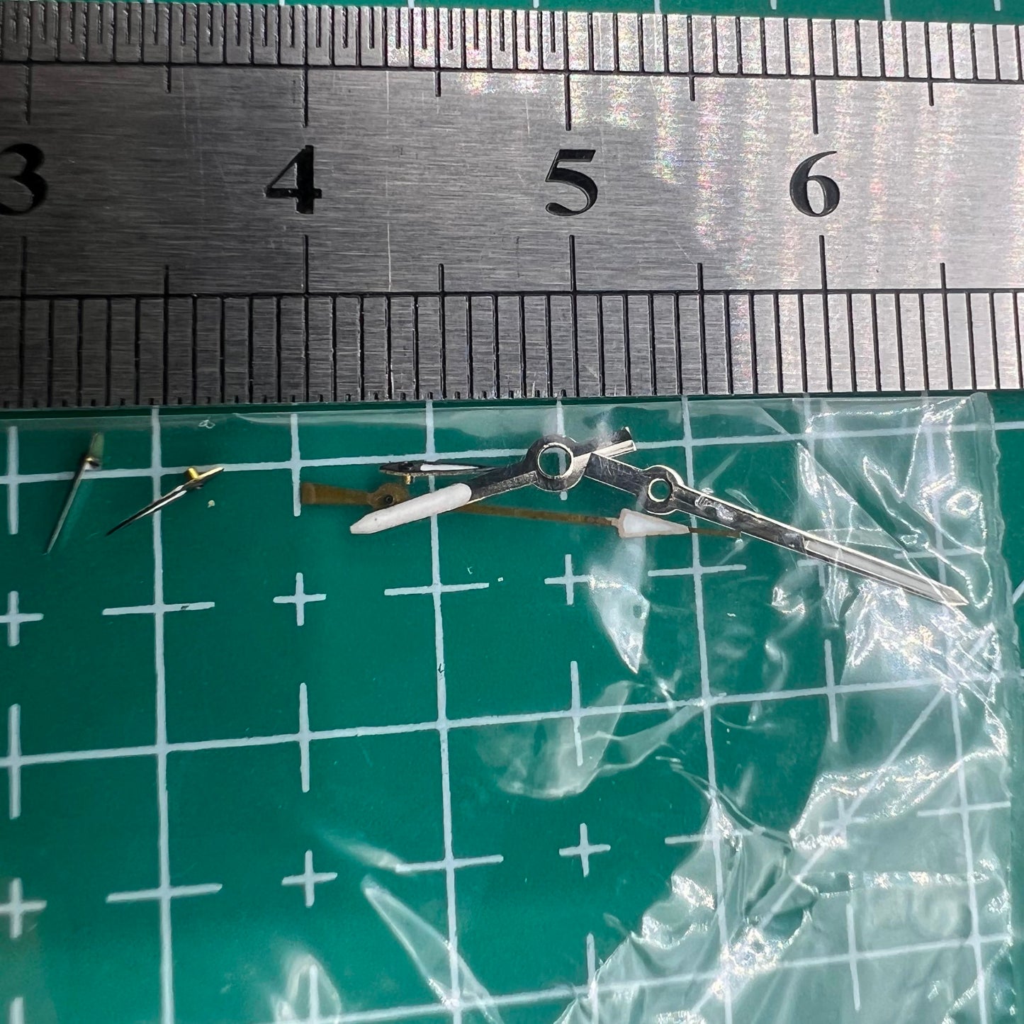 Silver and black 13mm luminous watch hands for Miyota OS series, enhancing visibility and style.