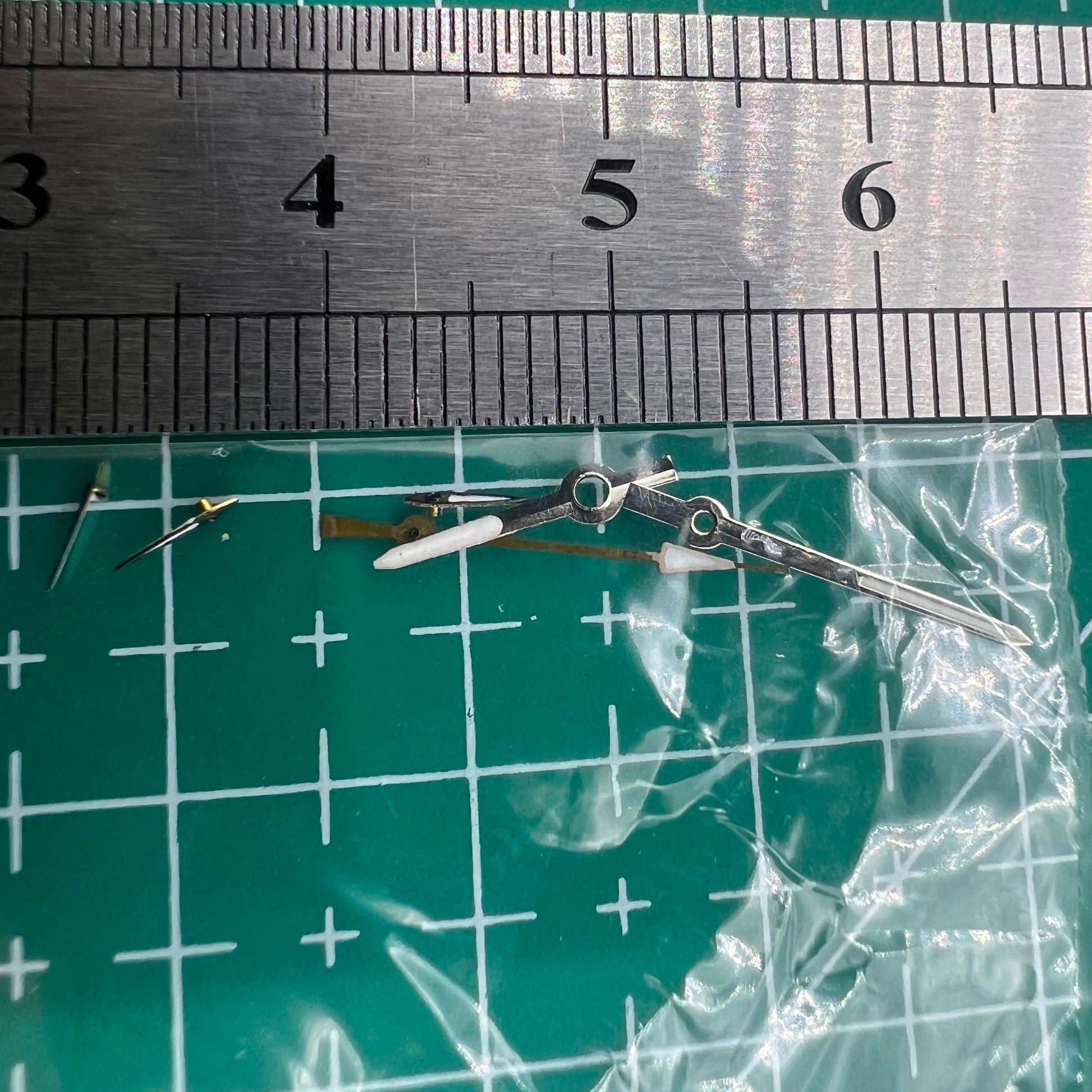 Silver and black 13mm luminous watch hands for Miyota OS series, enhancing visibility and style.