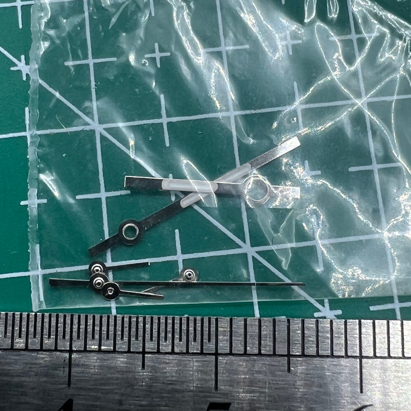 Silver watch hands with trim for Ronda 5030.D quartz movement, ideal for precision watch repairs and customization.