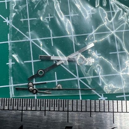 Silver watch hands with trim for Ronda 5030.D quartz movement, ideal for precision watch repairs and customization.