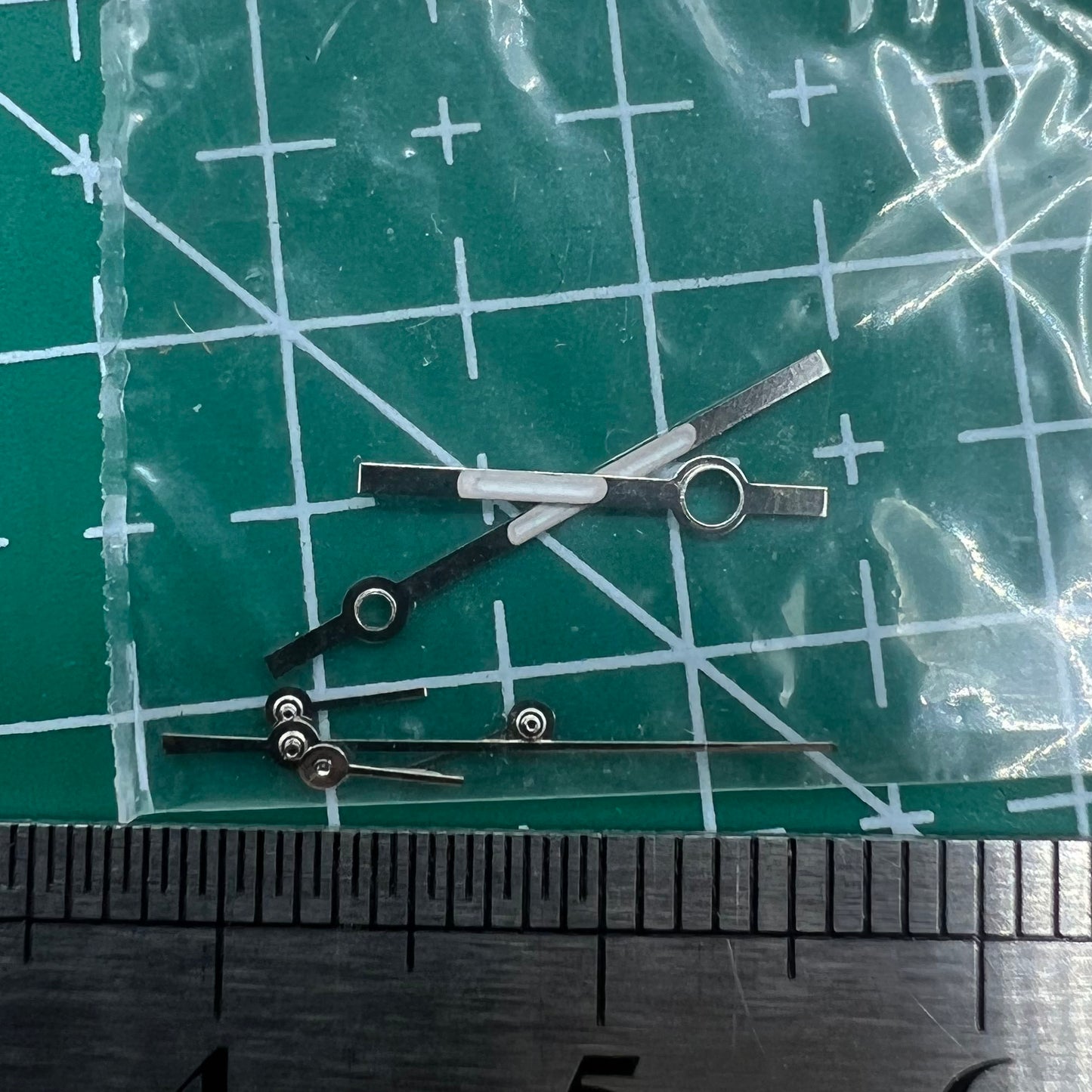 Silver watch hands with trim for Ronda 5030.D quartz movement, ideal for precision watch repairs.