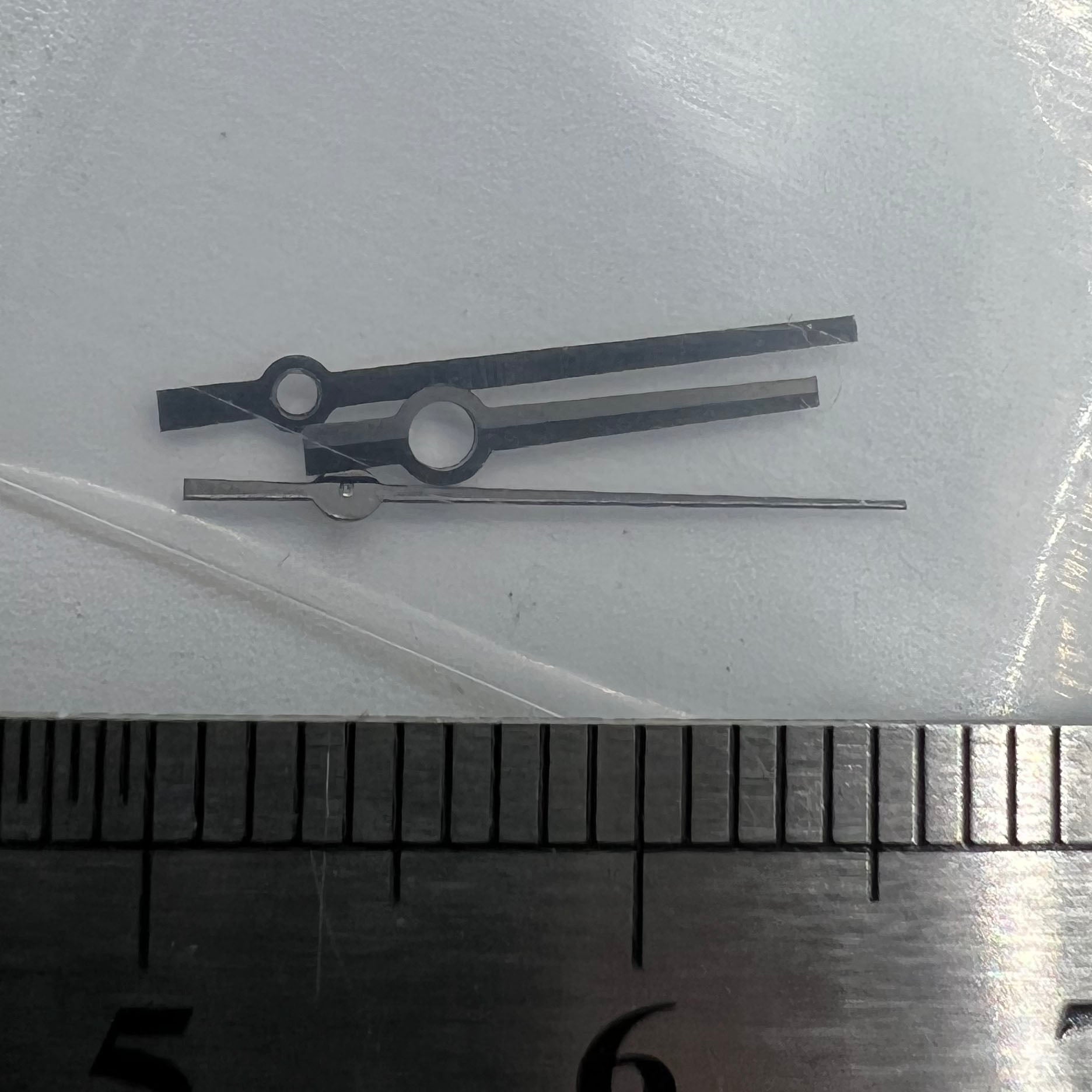 Black trim watch hands with no lume, compatible with NH35, NH36, 4R, and 7S movements, ideal for precise repairs.