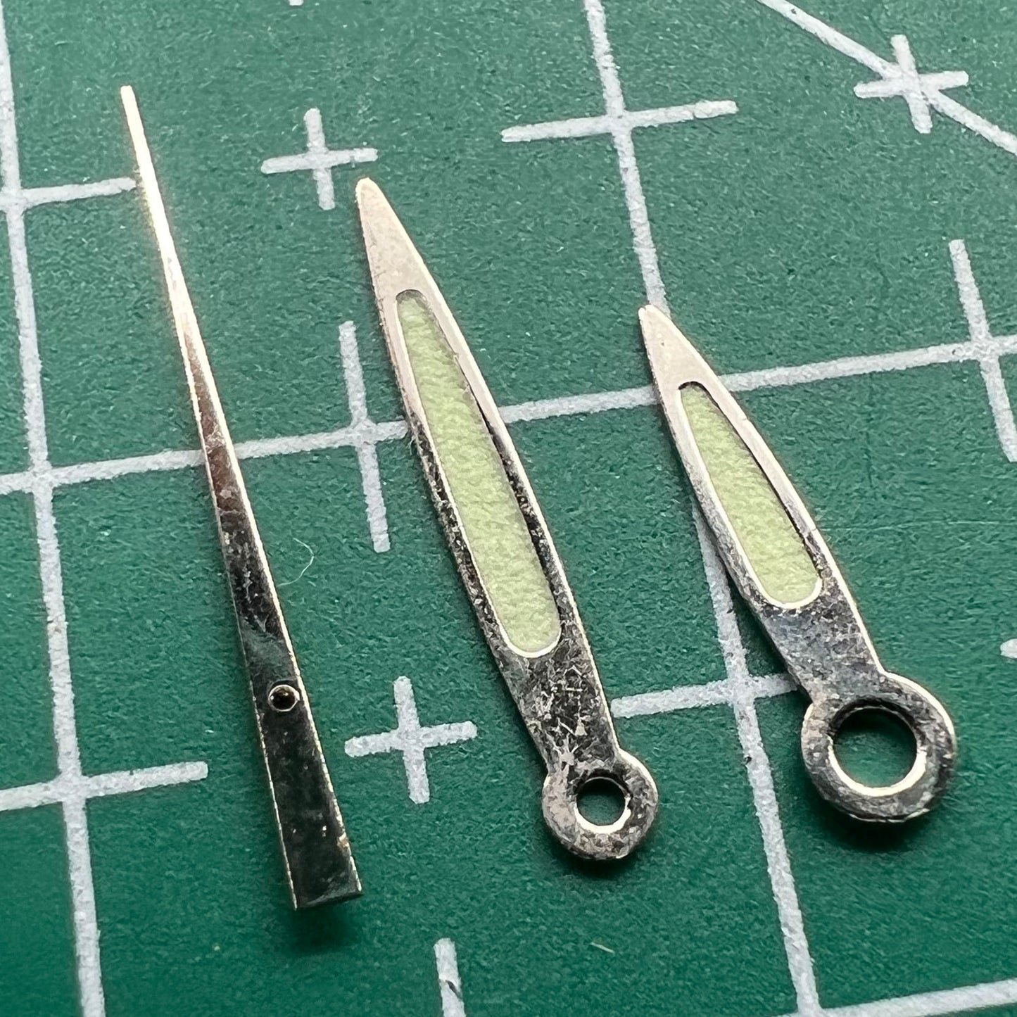 Arrow-shaped green luminous watch hands set for Miyota 2035, enhancing readability and style.