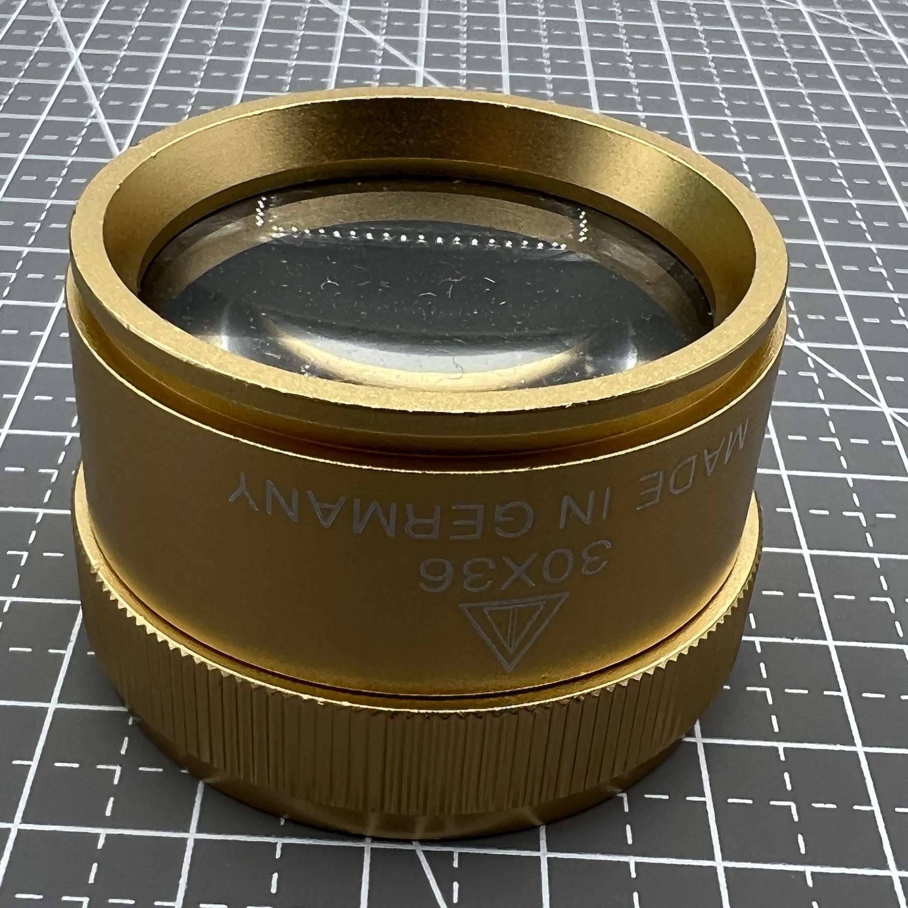 Germany-made bright golden 30X magnifier loupe, perfect for detailed watch repair and jewelry inspection.