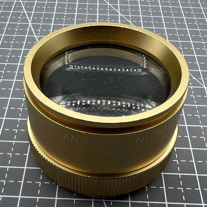 Bright golden 30X magnifier loupe, perfect for detailed watch repair and jewelry inspection.