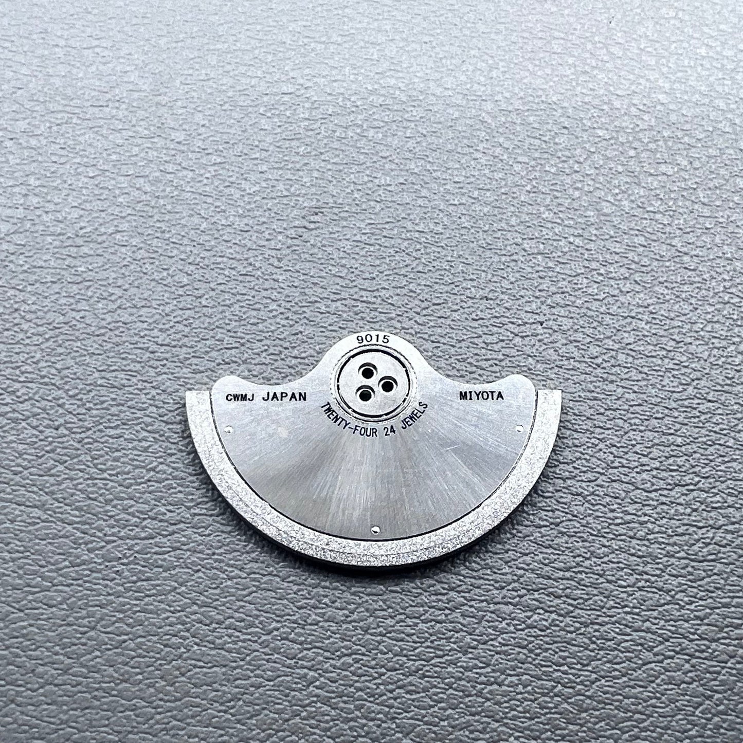 Silver rotor oscillating weight for Miyota 9015 mechanical watch movement, enhancing winding efficiency.