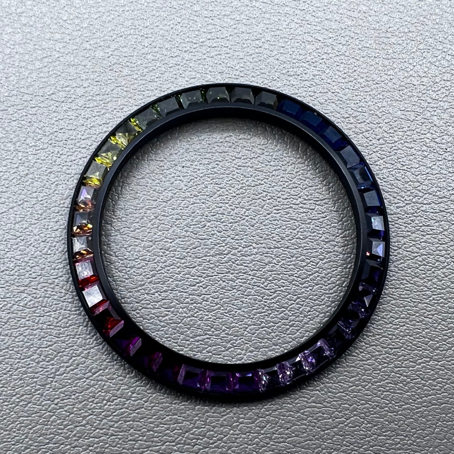 Daytona T-Shaped Square Moissanite watch bezel with inclined rainbow design on black base, luxury brand accessory.