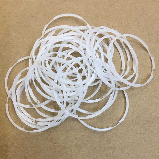 Set of 2 Seiko 7009A plastic watch movement spacer rings, 29x1.6mm, for precise watch repairs.