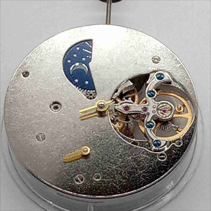 Silver mechanical flywheel watch part, precision movement component for watch repair and assembly.