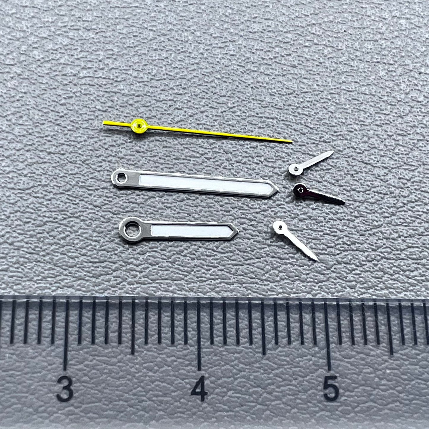 Silver-trimmed yellow lume watch hands with second hand for VD53, VD54, and VD57 movements.