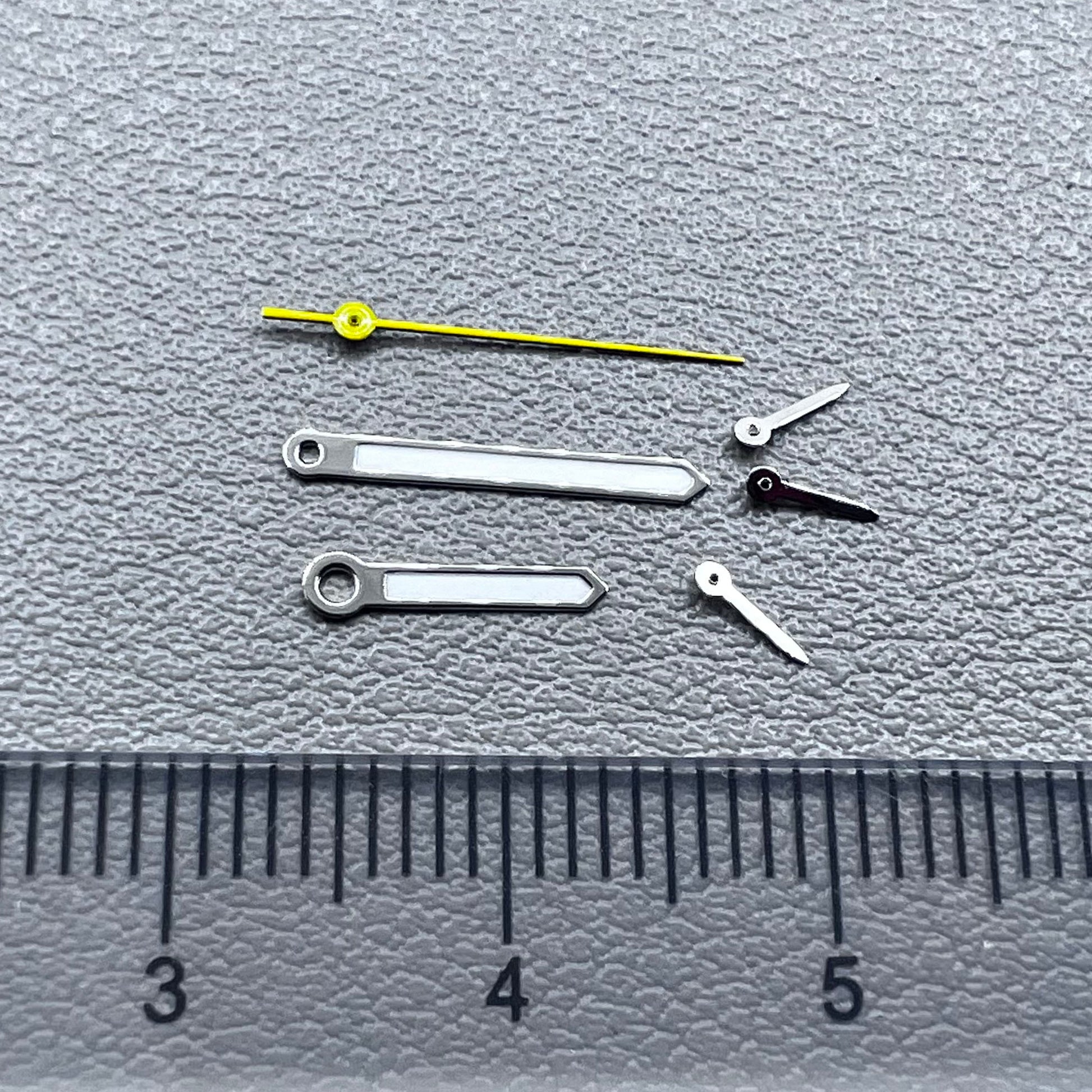 Silver-trimmed yellow lume watch hands with second hand for VD53, VD54, and VD57 movements.