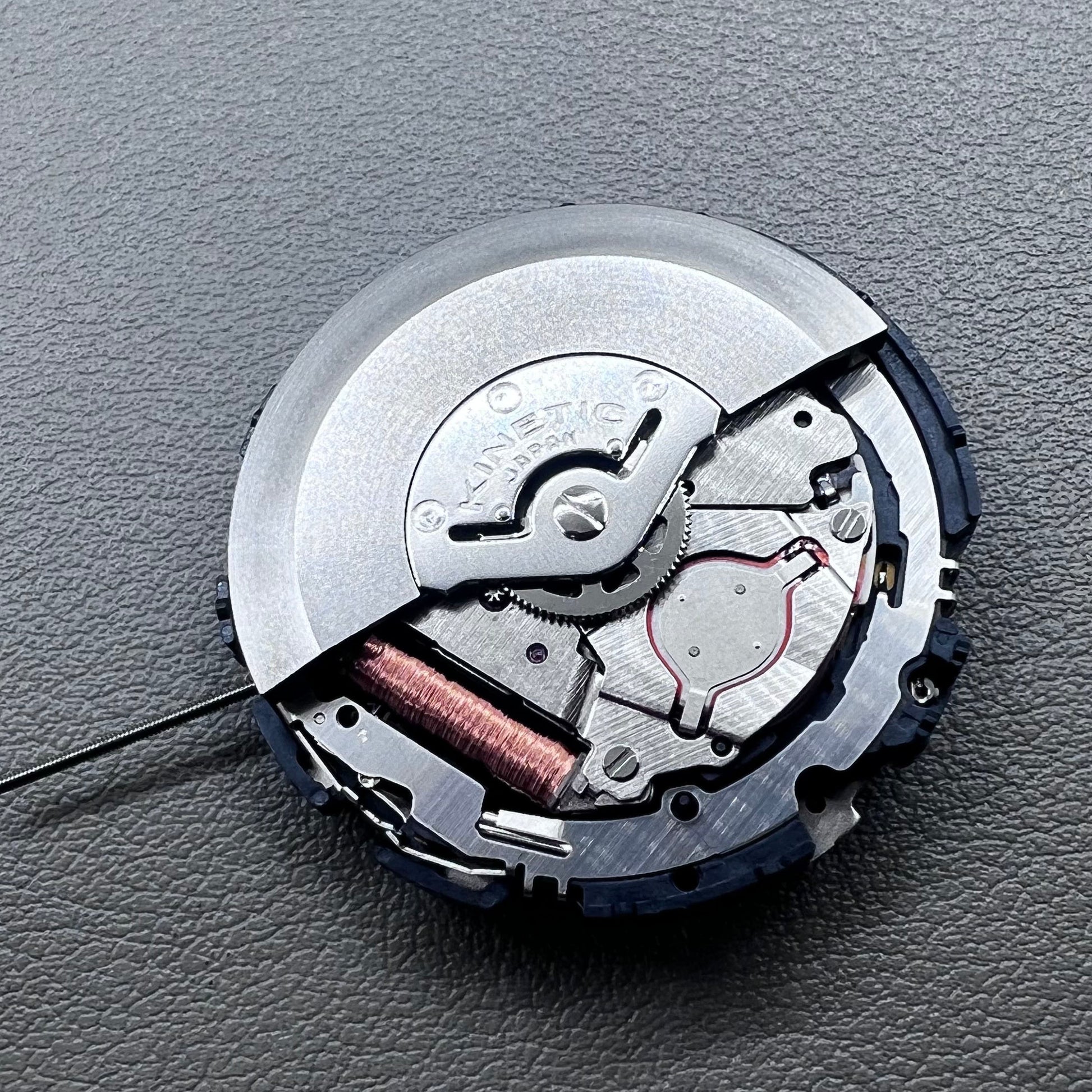 Original Japan Seiko 7L22A Quartz watch movement with black disk for precise timekeeping.