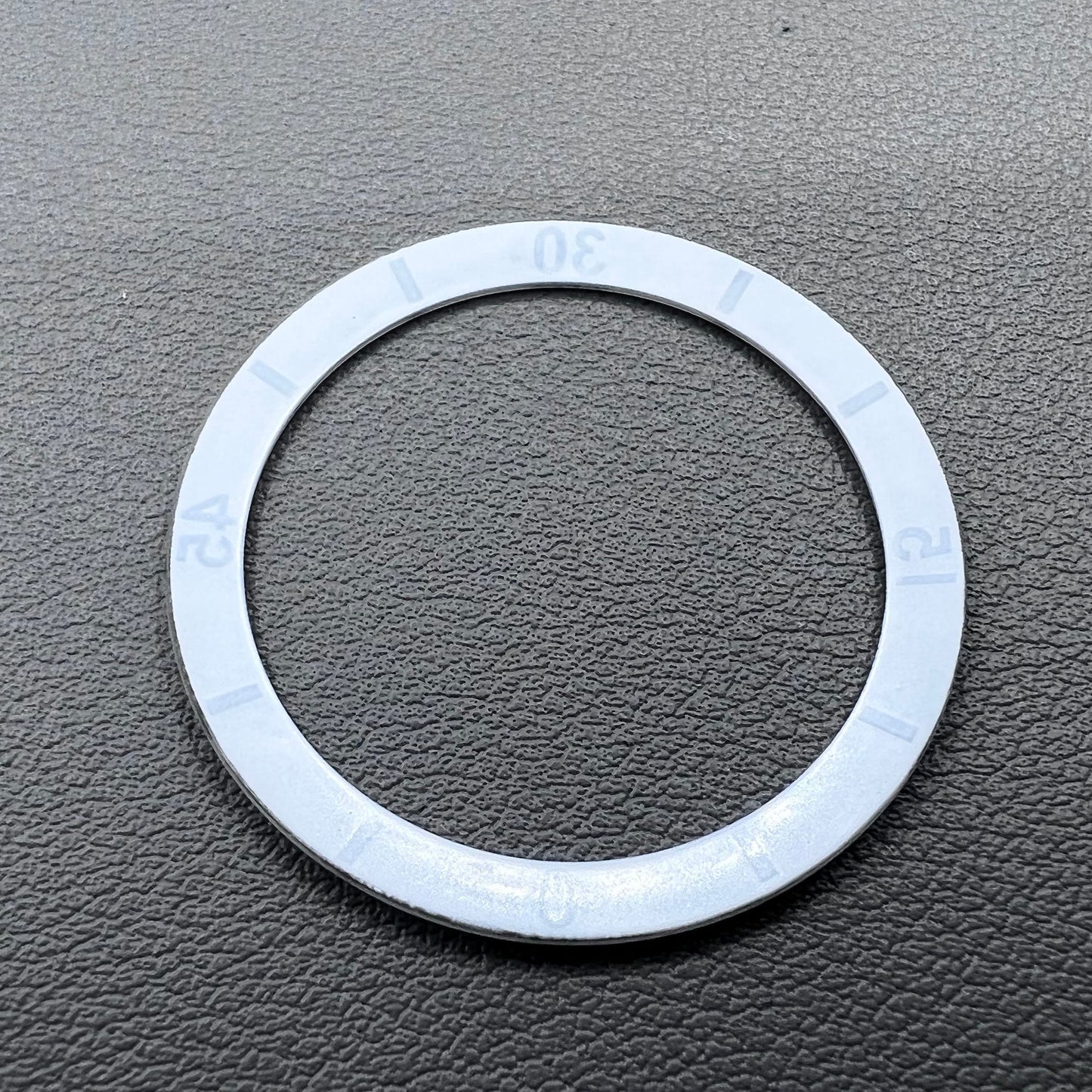 White 36mm ceramic watch bezel insert with numeral markings for men's and women's watches.