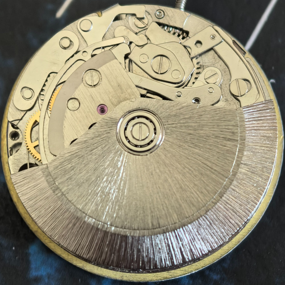 Chinese Dandong 7750 mechanical watch movement showing small second hand at 9 o'clock, frequency 21600 bpm