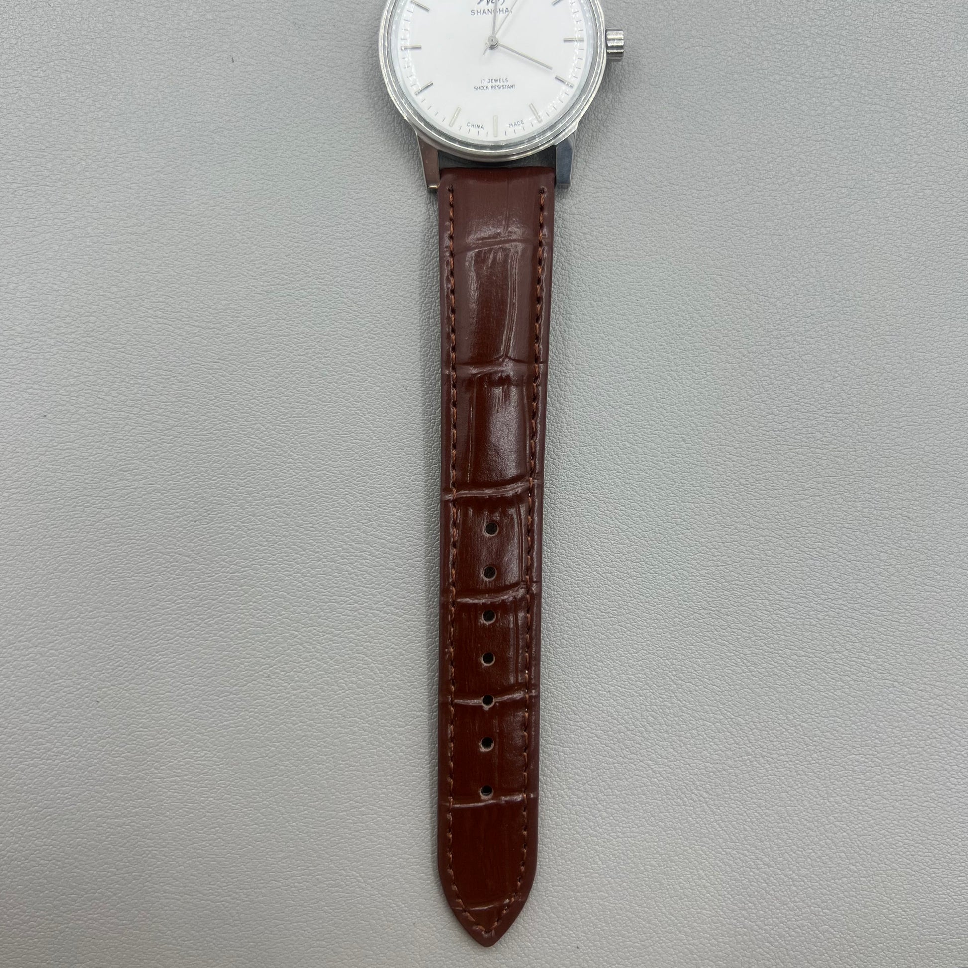 Shanghai 36mm 8120 manual mechanical watch with white dial, brown strap, 17 jewels precision craftsmanship.