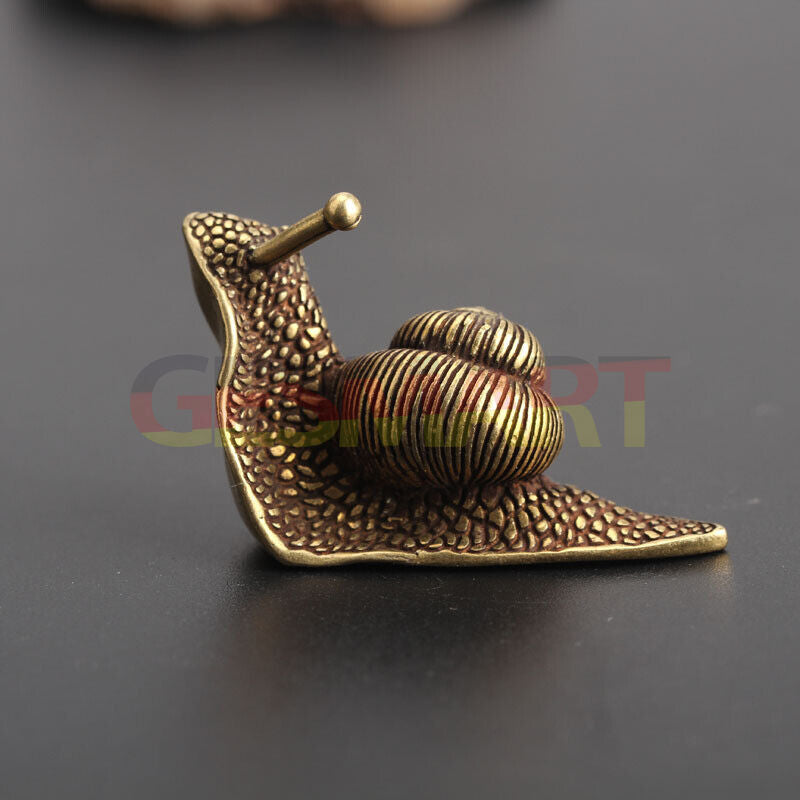 Hand-carved solid copper snail figurine with vintage bronze finish, ideal for watch accessory display.