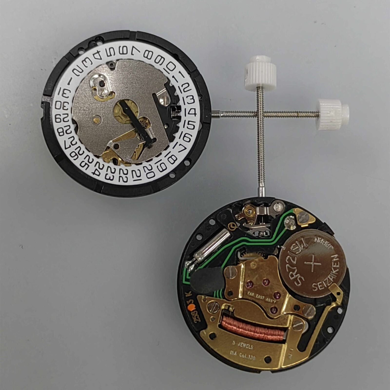 Watchmakers ISA 338 quartz movement repair part replacing J328/103 for accurate timekeeping maintenance.