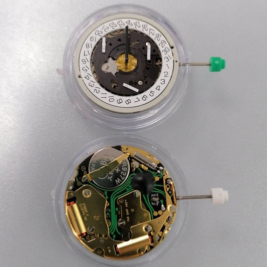 Watchmakers ISA 8172 golden quartz movement with date display at 4 o'clock and watch stem for precise timekeeping.