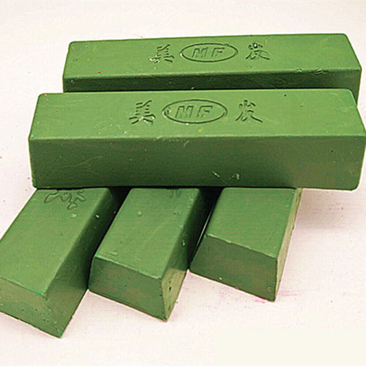 Green stainless steel polishing compound for jewelry and watch repair, enhancing shine and removing tarnish.