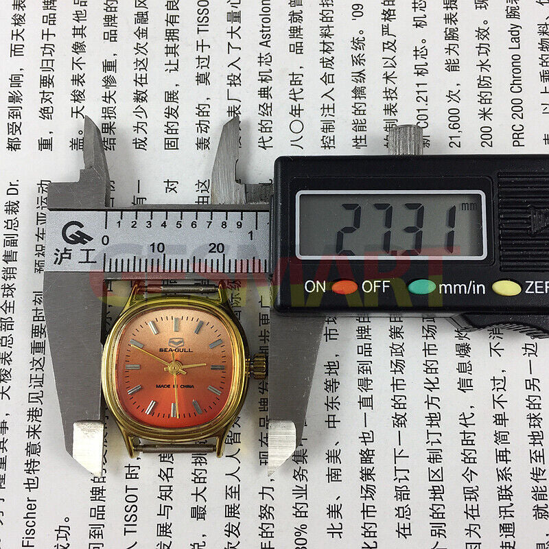 Seagull 27mm gold square watch with manual mechanical movement, elegant ladies accessory on orange background